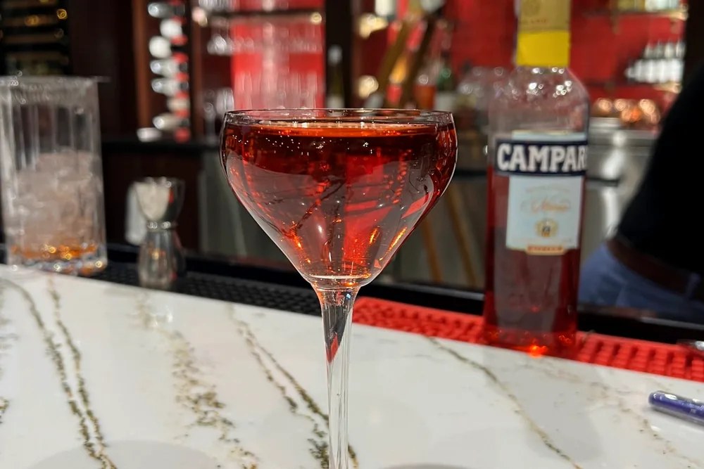 A Negroni Maribella on the marble bar top