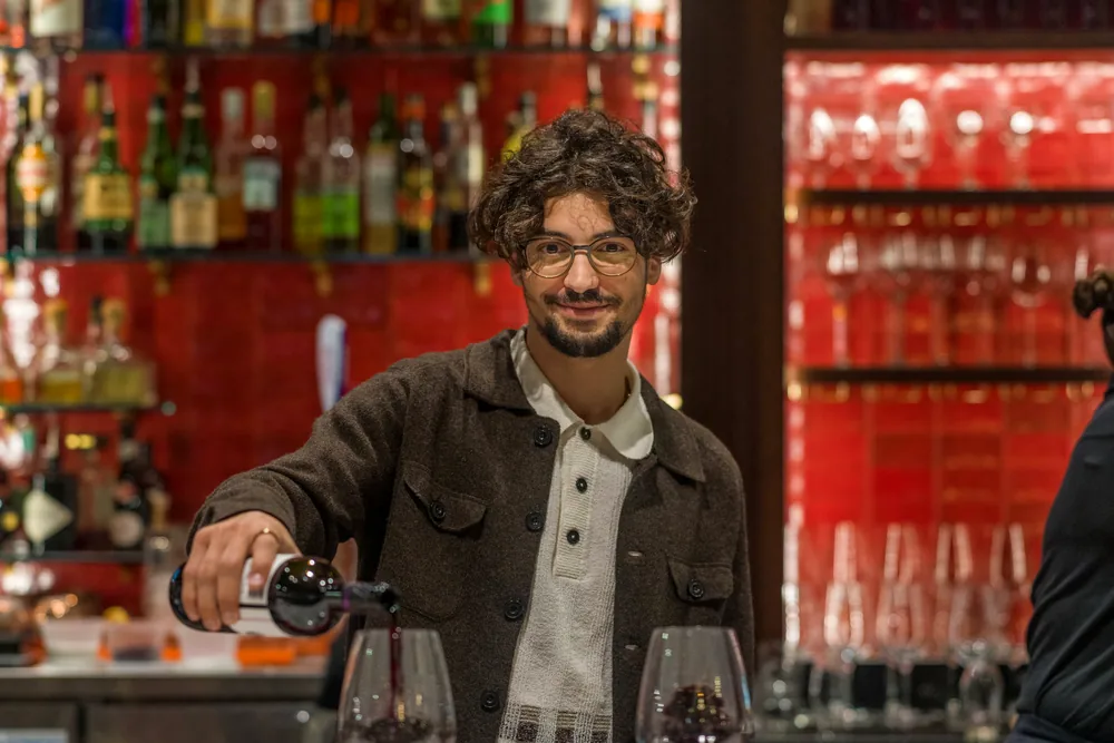 A glass being poured at the bar at Maribella